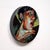 In "Captured Moment 2," a circular composition enhances the intimate portrayal of a figure engaged in self-reflection. The...