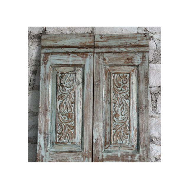 Make a bold architectural statement with this antique hand-carved barn door, featuring intricate floral motifs carved into...