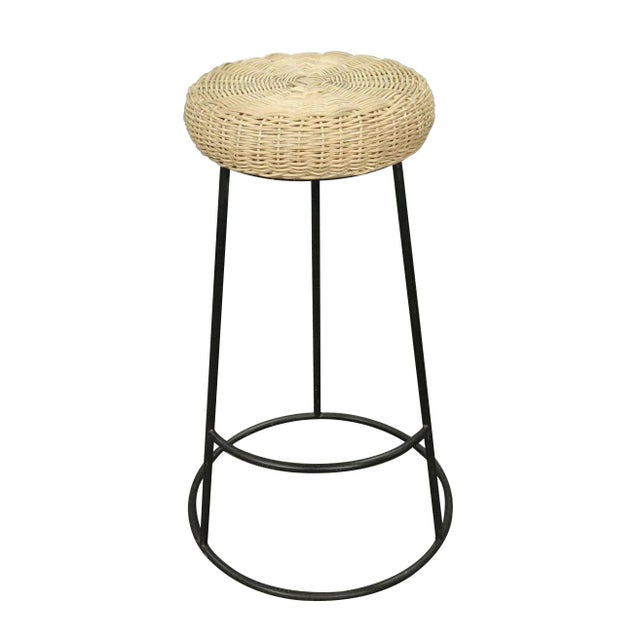 The Rattan Metal Stool from Zentique is a bar-height backless stool with a woven synthetic rattan barrel seat on a black...