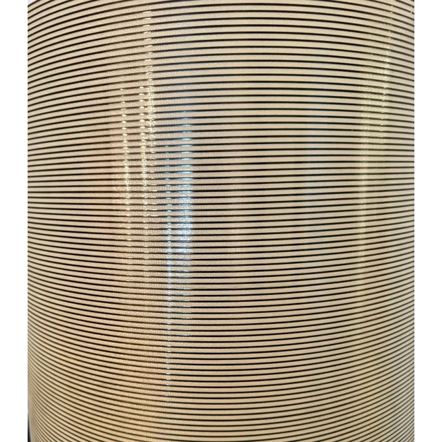 Foscarini floor lamp with black and white shade made with an innovative mixtureof fiberglass and carbon thread.