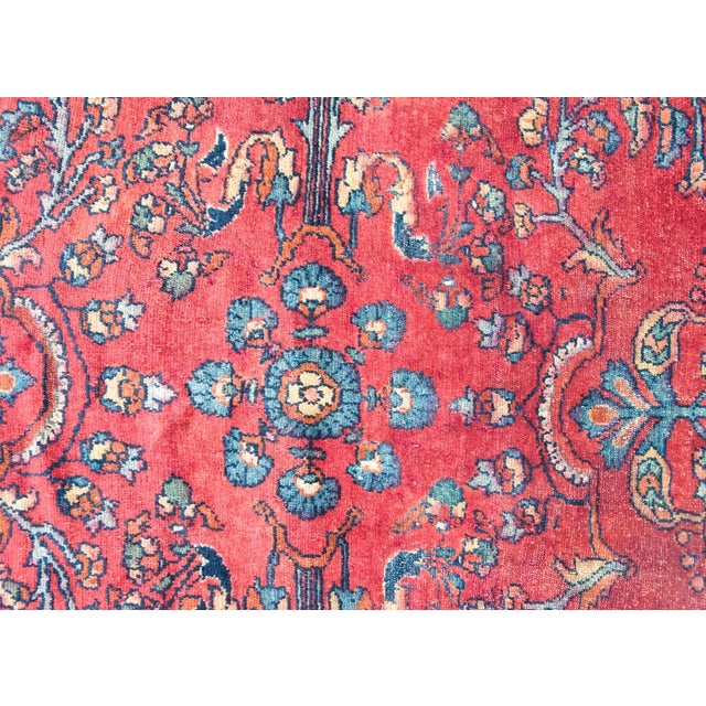 A beautiful early 20th century Persian Lilihan rug with a mirrored floral pattern with myriad floral clusters, surrounded...