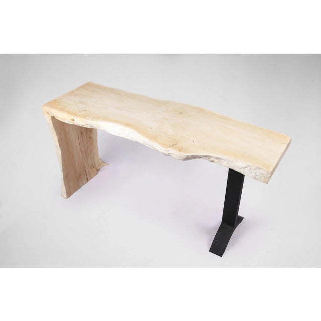 Almost straight cut top and living edge legs, this contemporary console table displays a clean, graceful, modernist...