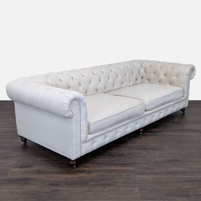 This elegant 3-seat sofa from Restoration Hardware features a timeless Chesterfield design with deep tufting, rolled arms,...