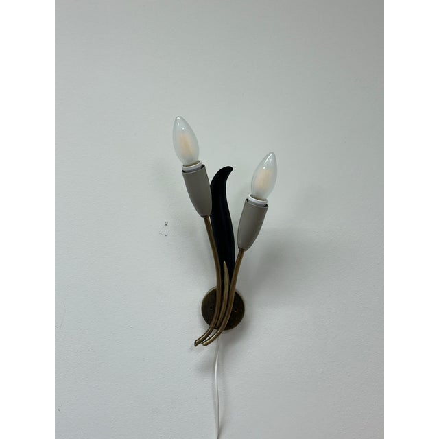 A wonderful wall light designed by Einar Bäckström featuring organic movement and Italian like styling. very stylish and...