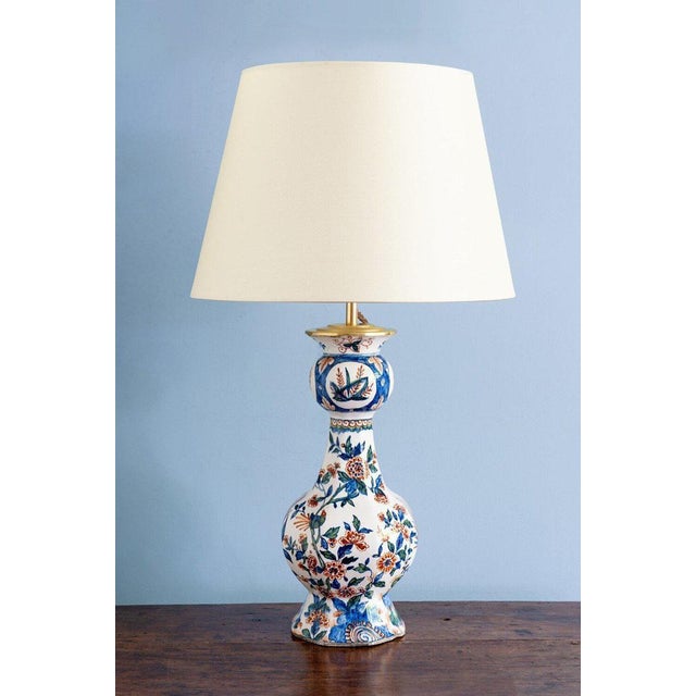 An 18th-century Dutch Delft garlic-neck vase, converted to a table lamp. Decorated in a vibrant palette of blue, red, and...