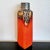 A tall, rectangular, persimmon-orange vase from Ü-Keramik that transitions at the shoulder to a round neck and mouth...