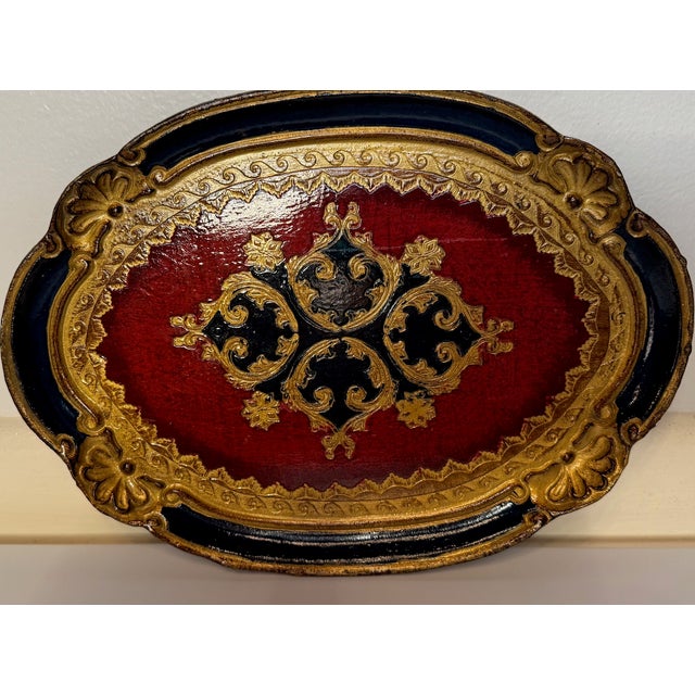 Striking vintage Florentine tray, handcrafted in Italy and richly decorated in a bold red, black, and gold palette....