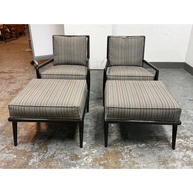 Design Plus Gallery presents a Pair of Mid 20th Century Lounge Armchairs + Ottomans by T.H. Robsjohn-Gibbings for...