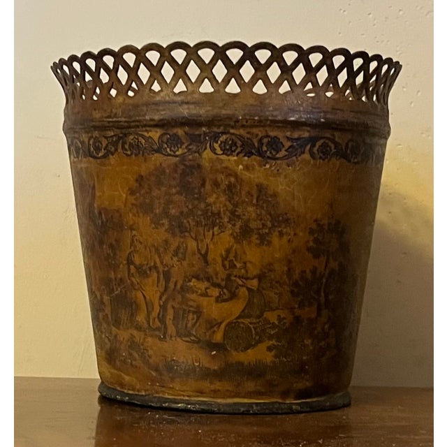 Antique 19th century French Empire tole cachepot in mustard paint. Decorated with figures in a country landscape. Measures...