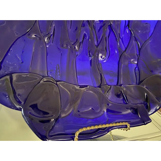 Photos don't capture the beauty on this one. Heavy hand formed plate comprised of about 14 stunning cobalt blue bottles....