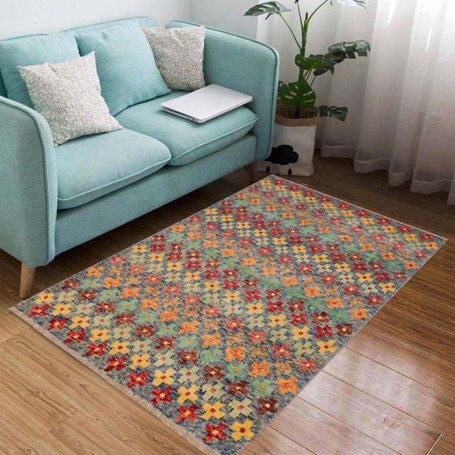 This stunning hand-knotted Afghan Balouchi rug is a captivating addition to any decor. Crafted by skilled artisans, it...