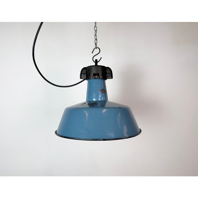 Industrial blue enamel pendant light made by Polam Wilkasy in Poland during the 1960s. White enamel inside the shade. Cast...