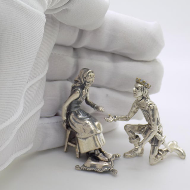 Capturing one of the most iconic moments in european fairytale lore, this rare two-piece silver figurine set depicts...