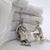 Capturing one of the most iconic moments in european fairytale lore, this rare two-piece silver figurine set depicts...