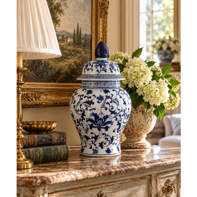 A classic blue and white ginger jar, decorated throughout with a delicate flowering branch motif. The pattern is dense yet...