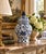 A classic blue and white ginger jar, decorated throughout with a delicate flowering branch motif. The pattern is dense yet...