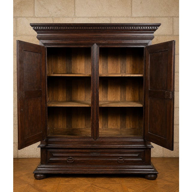 An important Louis XIII period Burgundian armoire, crafted from walnut, boasting a powerful architectural style and...