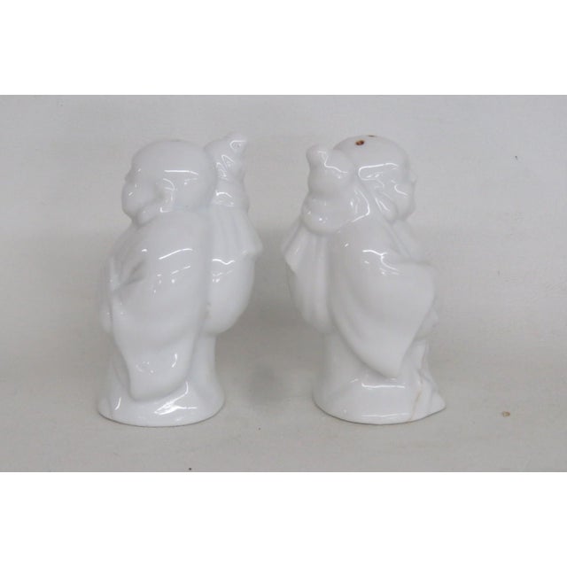 This lovely Pair of 2 Salt & Pepper Shakers is made out of ceramic. These darling shakers are designed as matching Hotei /...