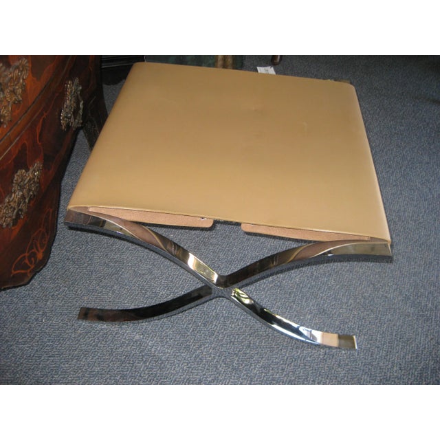 Classic chrome X shaped design with a stretched leather seat. The leather has a slight pucker on the top. Purchased at the...