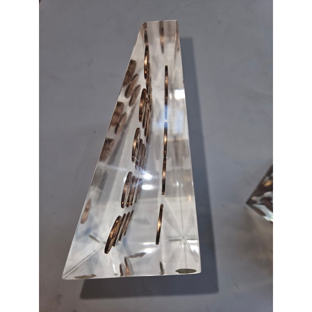 Pair of triangluar shaped Lucite Bookends embedded with pennies all dated 1972. Excellent condition.