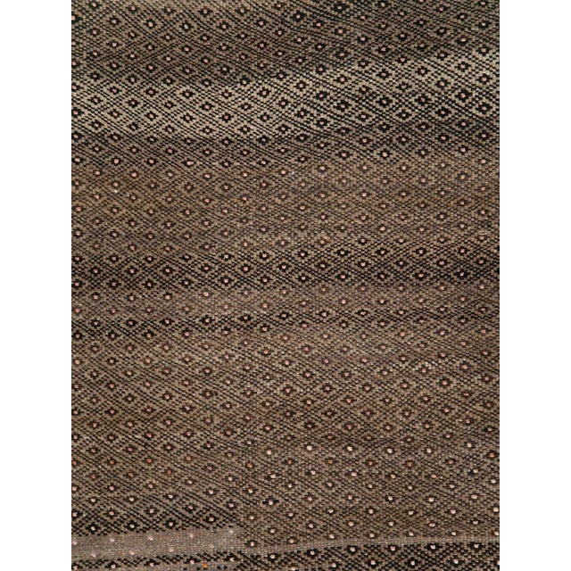 A vintage Turkish Anatolian room size rug handmade during the mid-20th century with an open field tribal design. Measures:...