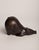 An Art Deco–style animal bronze of a pig, its body pared down to a single rounded, swelling volume that tapers to a...