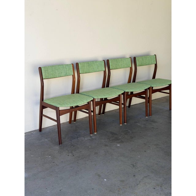 Beautiful set of 4 vintage Danish modern dining chairs crafted in solid teak, designed in the style of Erik Buch. These...