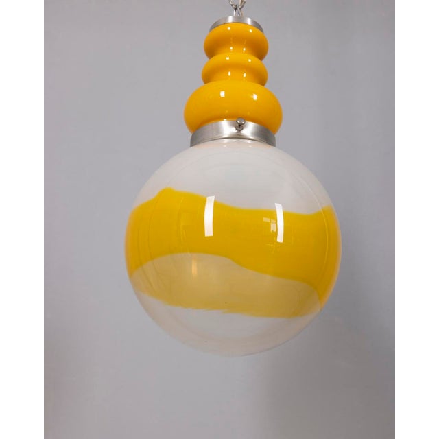 Chandelier with yellow metal body and large spherical lampshade in white and yellow opal glass, Italian Space Age design,...