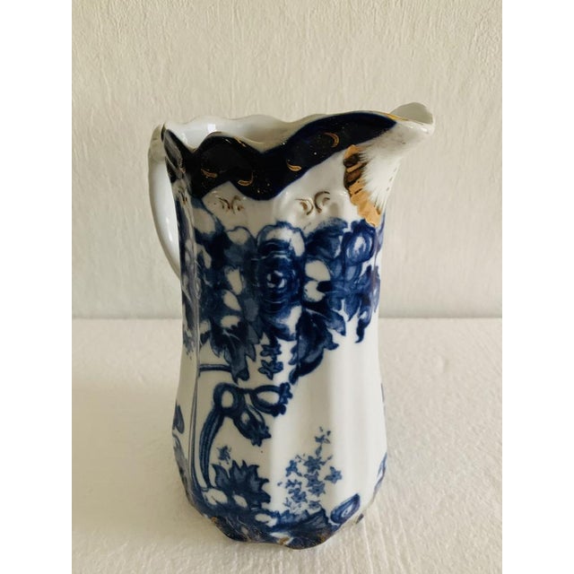 Beautiful, flow blue antique pitcher/jug, by Doulton Burslem, circa 1890's. Piece has been designed between 1862 - 1902....