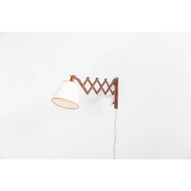 Vintage Scandinavian design wall lamp, so called scissors lamp with extendable wood arm and fabric shade.Condition Age...