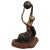 Abstract figurative sculpture of a women holding a globe above her head and is sitting in the palm of a hand. The bronze...