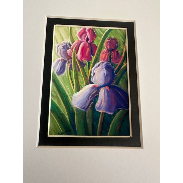 A charming miniature floral composition featuring an exuberant gathering of coral, rose, yellow, and lavender blossoms...