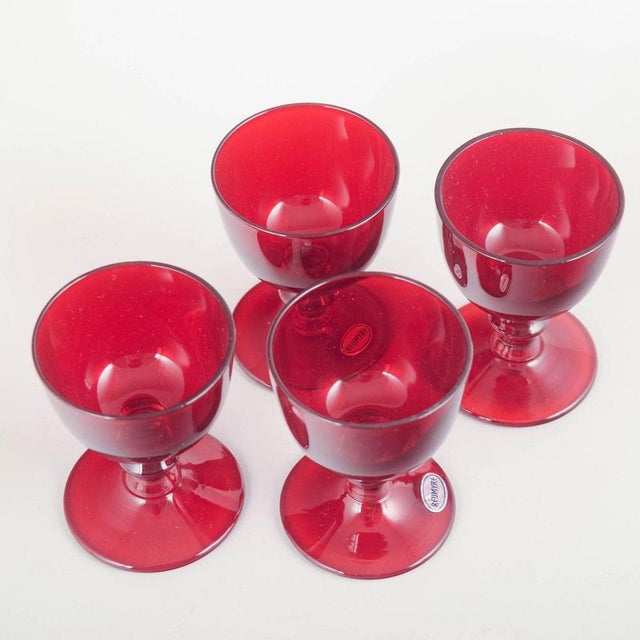 Reijmyre Glasbruk 4 port wine glasses, 1950s. Set of four ruby-red port wine glasses with rounded bowls and profiled...