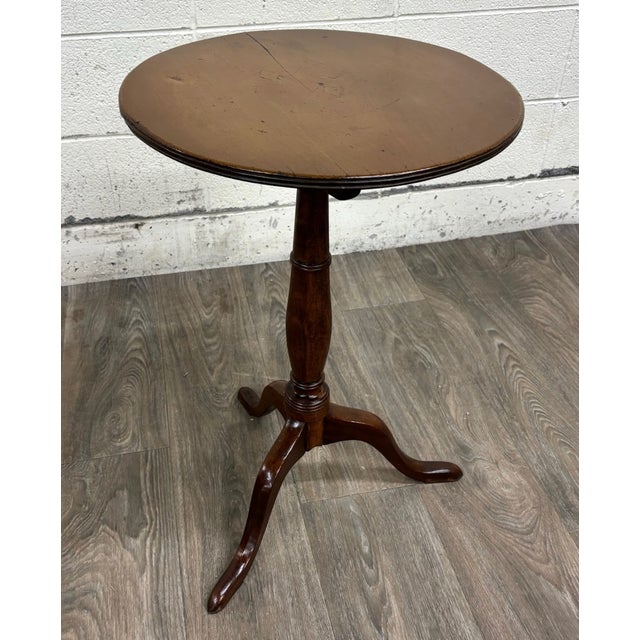 This is a stunning antique 19th century mahogany tilt-top tea or occasional table featuring a round top, turned pedestal...