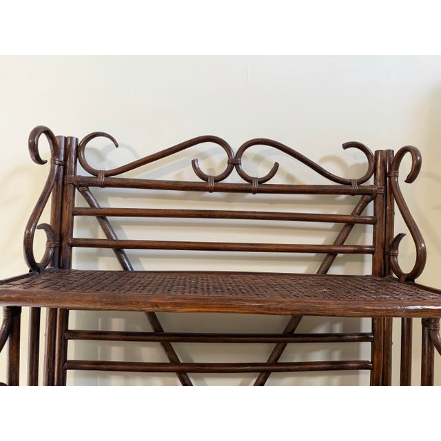 Sculptural vintage rattan étagère in the style of McGuire, featuring an elegant combination of bundled rattan...