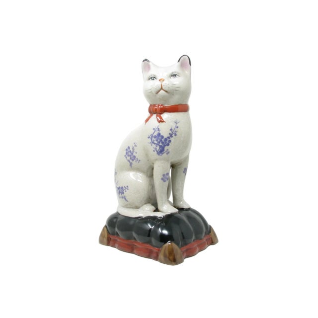 Vintage large ceramic sculpture of a cat sitting on a pillow. Beautiful floral pattern and crackled glaze.