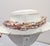 1981 goldtone multi-strand torsade resin faux-mother-of-pearl in shades of pink, purple, white, yellow and grey with bow...
