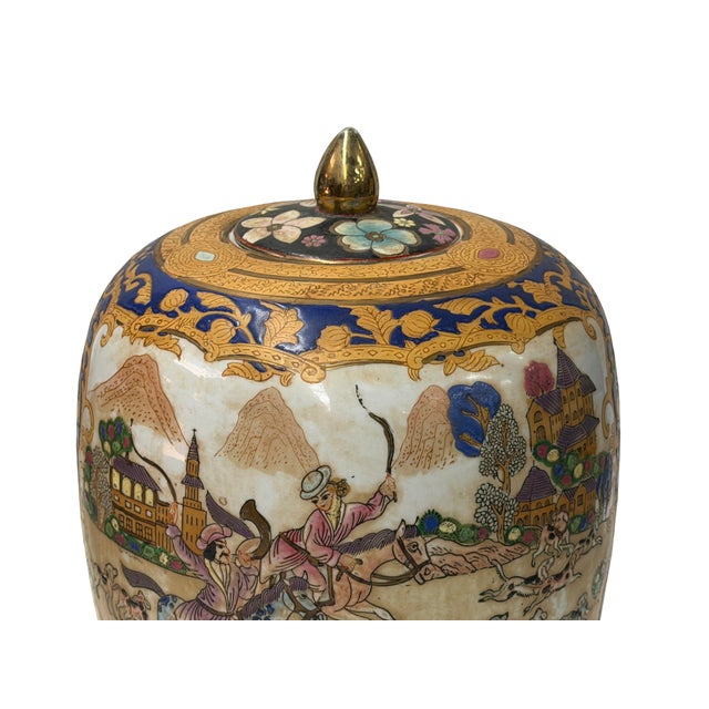 This vintage porcelain ginger jar with a fitted lid showcases a vibrant, richly detailed hunting scene. The body features...