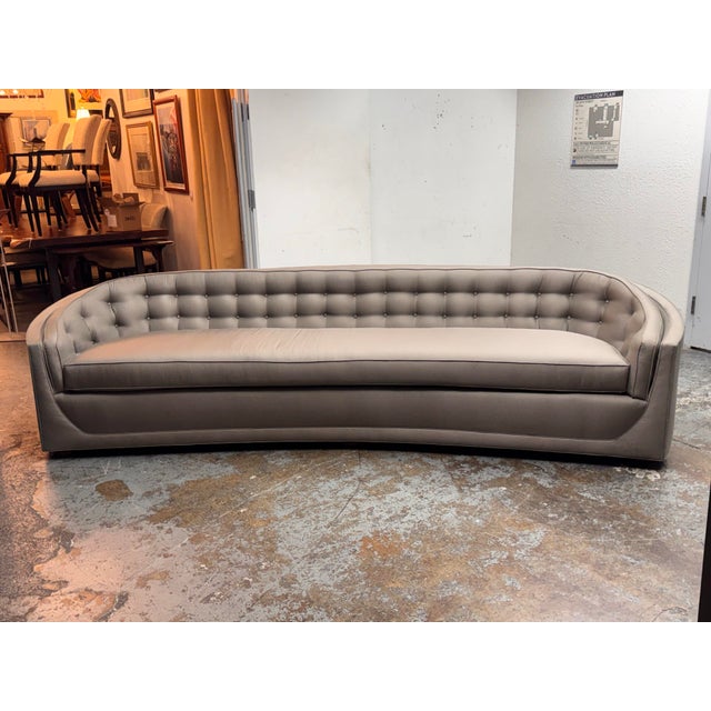 Design Plus Gallery presents a Bespoke Curved Tufted Tuxedo Sofa in Taupe Upholstery. This custom sofa has a curved tuxedo...