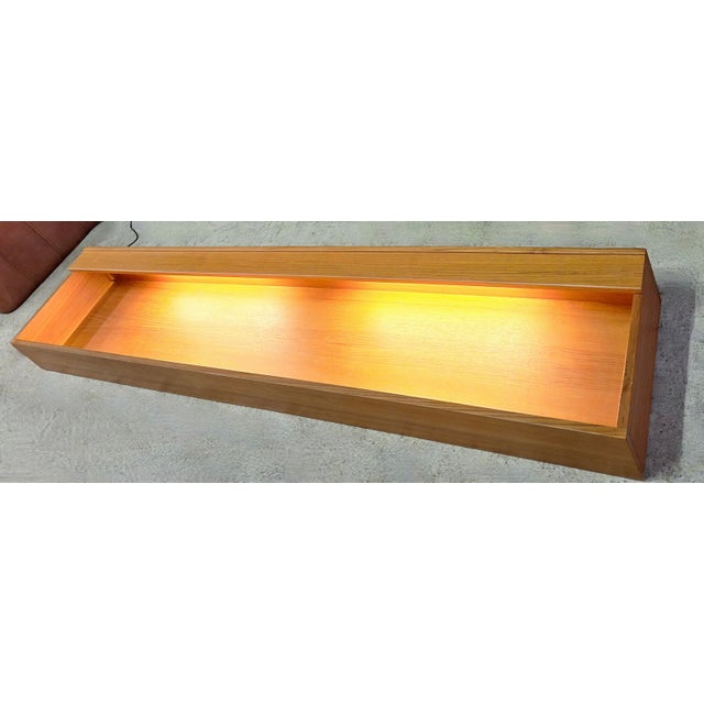 Danish extra long teak floating sideboard / shelf dating from about 1960, finely-shaped teak casing enclosing shelf, with...