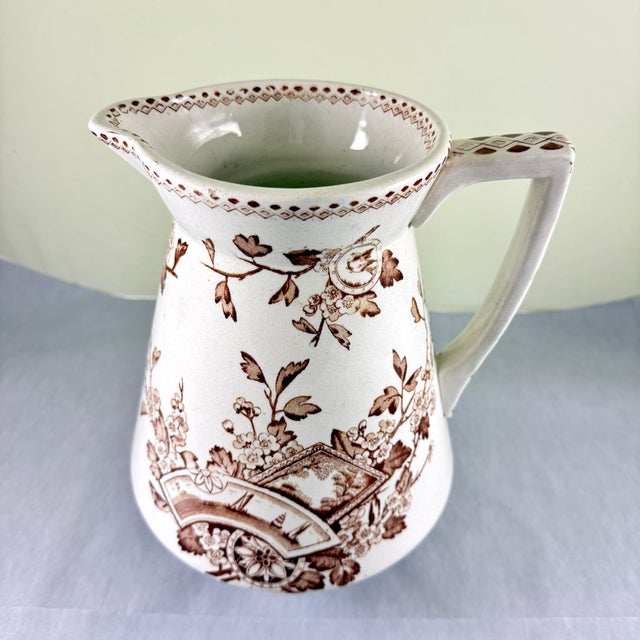 An oversized ironstone pitcher in the Aesthetic Taste, made by Holmes, Plant & Mayday at The Sylvester Pottery Works –...