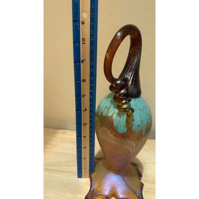 This 12 inch sculpture features a “goose neck”style and an iridescent finish created using techniques inspired by Tiffany...
