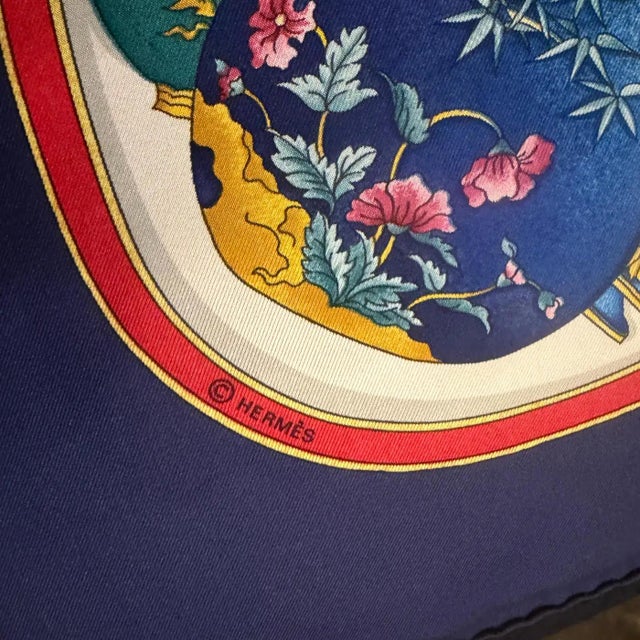 This vintage Hermès silk scarf features the celebrated "Qu'importe le flacon..." design by Catherine Baschet, an iconic...