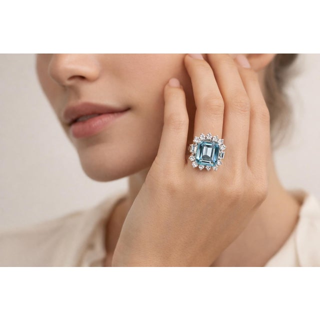 Elegant 14K white gold ring featuring a striking emerald cut aquamarine center stone weighing approximately 4.00 carats,...