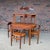 Exceptional Danish Modern teak dining set designed by Hans Olsen, featuring his ingenious space-saving chair design in...