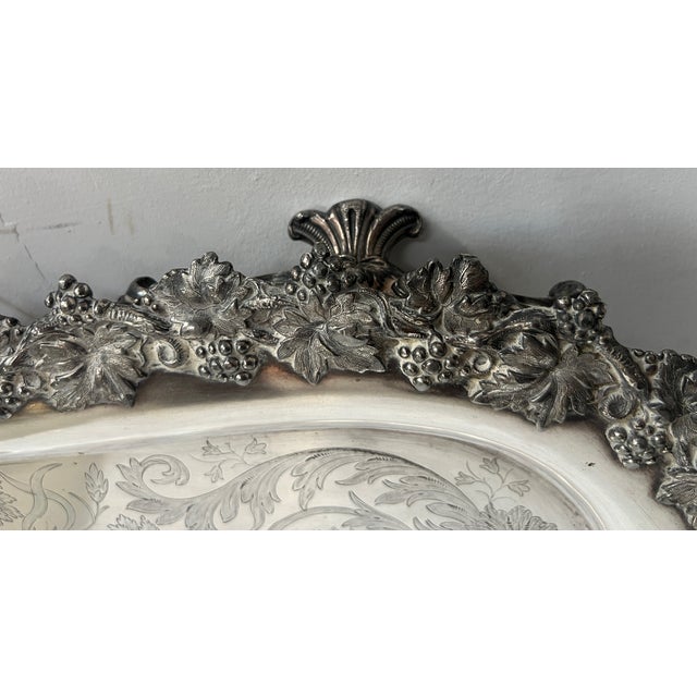 Important, richly sculpted silver-plated tray rich high-relief decoration on the rim and handles decorated with vine...