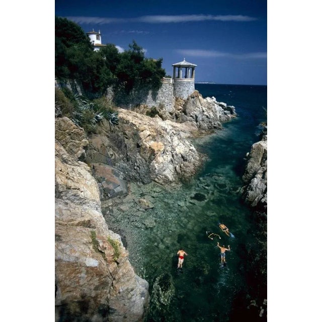 Swimming In Spain 1970 by Slim Aarons Slim Aarons Limited Estate Edition Swimming and snorkelling in the bay at the Hostal...