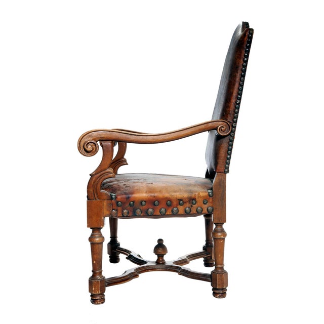 An Antique Gentlemans Occasional European Leather Chair with metal studs all around. Wood Frame with Antique Leather seat...
