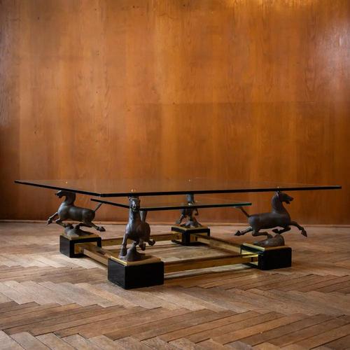 An exceptionally elegant coffee table by Maison Charles, distinguished by four sculptural bronze Flying Horses of Gansu in...