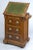 This unusual mahogany cabinet/desk has an adjustable lift-top writing slope with carved gadrooned edge, green gilt-tooled...